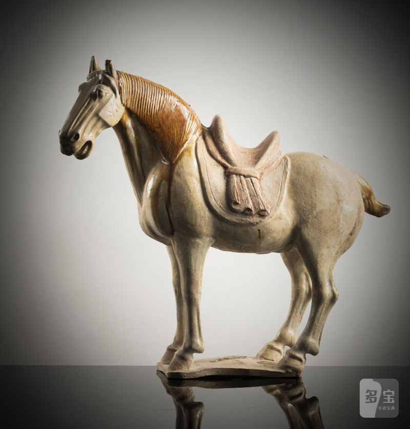 A partly amber-glazed earthenware figure of a standing horse